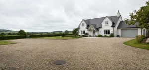 Rural home driveway with septic tank access cover