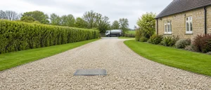 Tidy rural driveway with septic tank access ready for liquid waste collection.